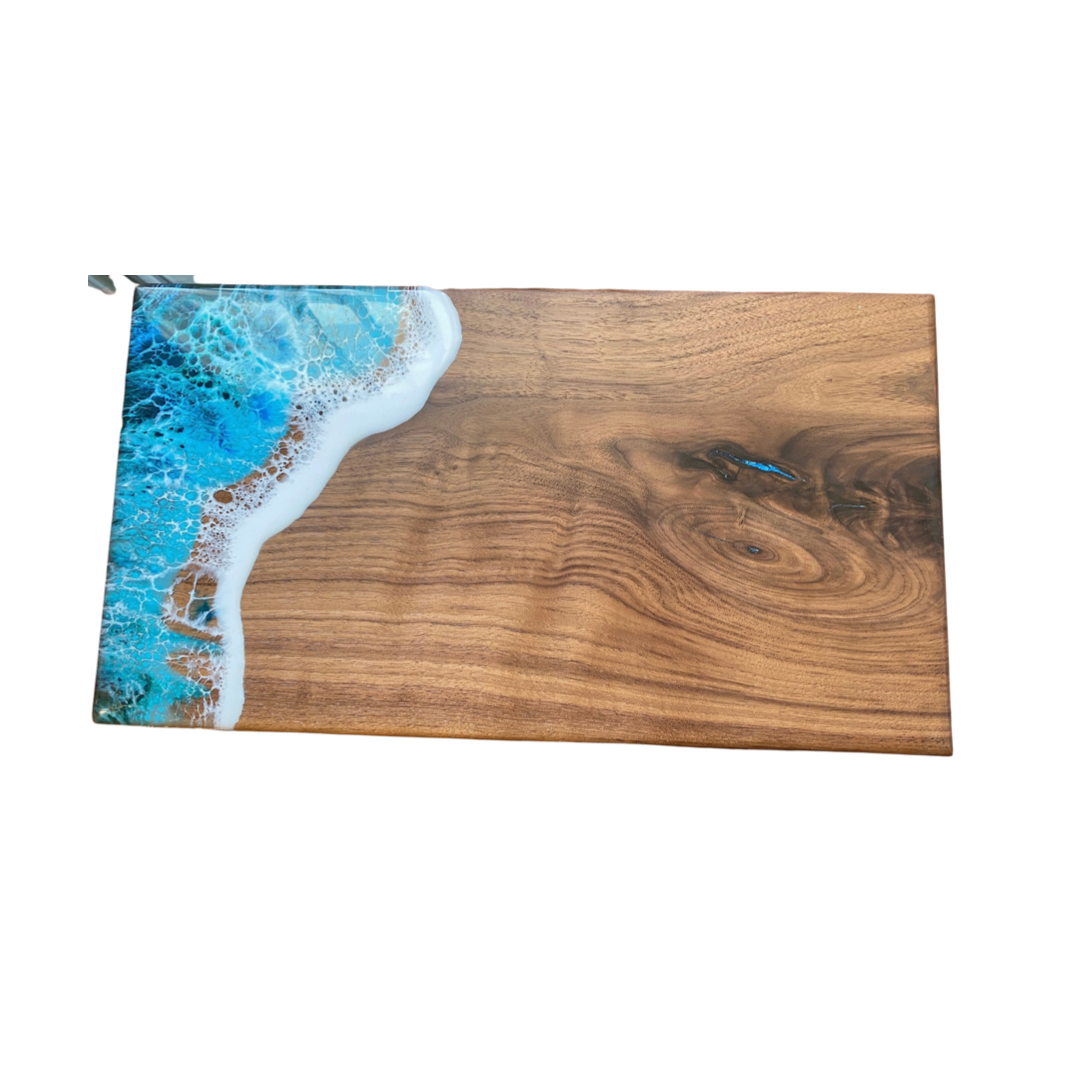 Black walnut ocean wave serving board with small knot filled with blue resin